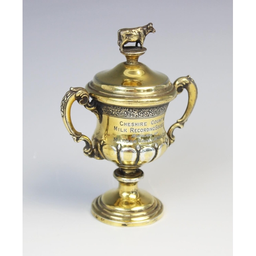 30 - A George V miniature silver gilt cup and cover by Elkington & Co, Birmingham 1930, of baluster form ... 