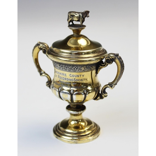 30 - A George V miniature silver gilt cup and cover by Elkington & Co, Birmingham 1930, of baluster form ... 