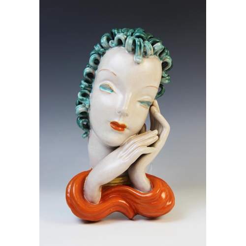 503 - An Art Deco Goldscheider wall mask, early 20th century, modelled as a lady with blue curled hair and... 