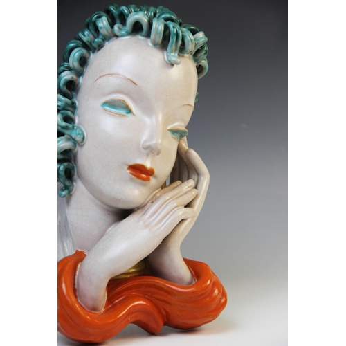 503 - An Art Deco Goldscheider wall mask, early 20th century, modelled as a lady with blue curled hair and... 