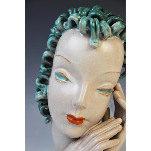 503 - An Art Deco Goldscheider wall mask, early 20th century, modelled as a lady with blue curled hair and... 