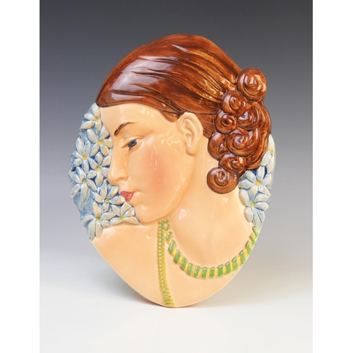 509 - An Art Deco wall mask of large proportions, probably by Beswick, the gloss glazed mask modelled as a... 