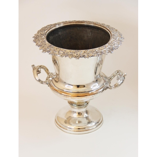 69 - A silver plated twin-handled campana wine cooler, with cast grape and vine rim on domed circular foo... 