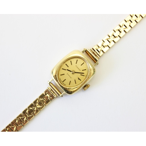 86 - A lady's vintage 18ct gold Tissot Saphir wristwatch, gold toned oval dial with baton markers, set to... 