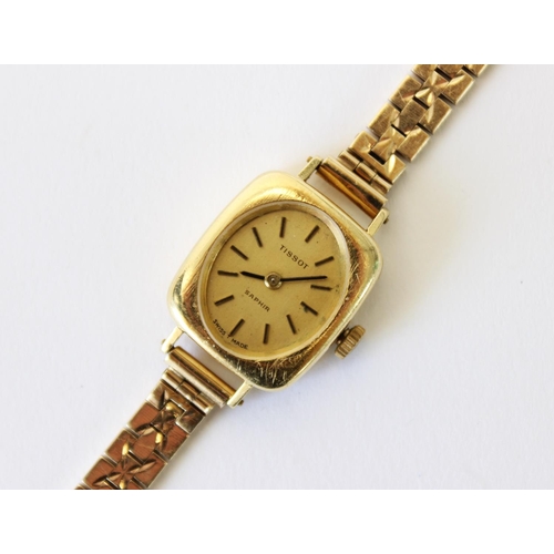 86 - A lady's vintage 18ct gold Tissot Saphir wristwatch, gold toned oval dial with baton markers, set to... 