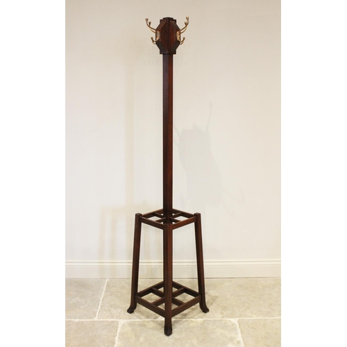 863 - An early 20th century Arts and Crafts mahogany freestanding coat/hat stand, the four brass hooks mou... 