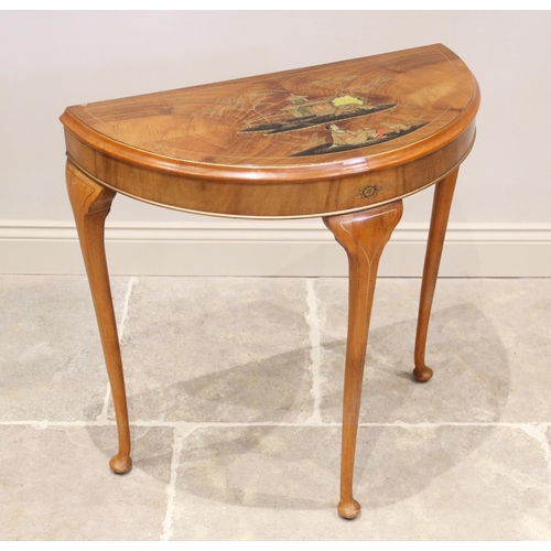 865 - An early 20th century Japanned walnut demi lune hall table, the table top applied in gilt relief dep... 