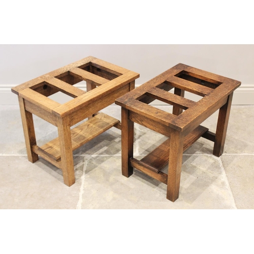 866 - A pair of honey oak luggage stands, 20th century, each with a rectangular slatted top on legs of squ... 