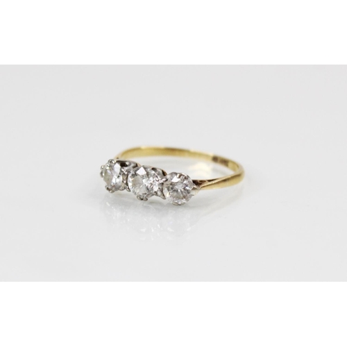 109 - A diamond three stone ring, comprising a central round brilliant cut diamond (weighing approximately... 