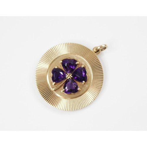 155 - A 14ct gold amethyst 'lucky' clover pendant, the central raised clover motif comprising four heart-s... 