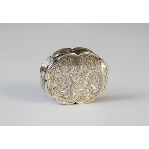 49 - A Victorian silver vinaigrette by Edward Smith, Birmingham 1856, of oval form with scalloped borders... 