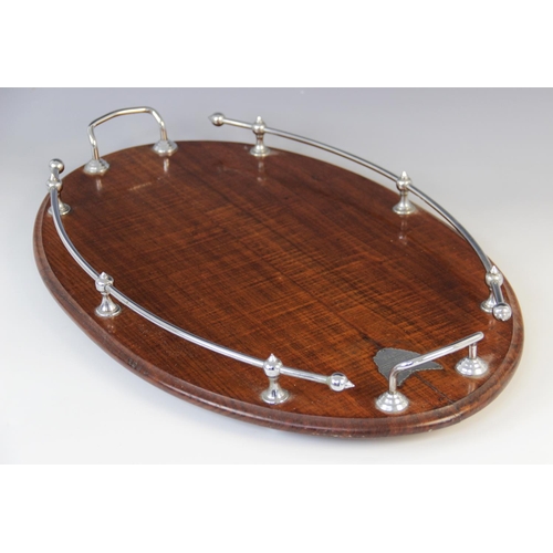57 - An early 20th century mahogany gallery drinks tray, of oval form with white metal handles, with silv... 