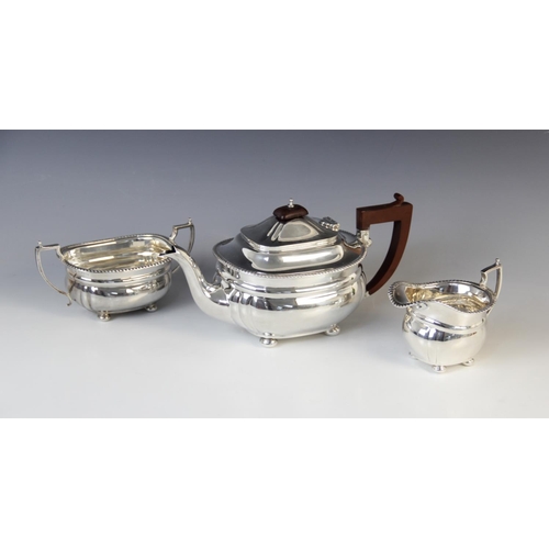 64 - A George V three-piece silver tea service by Adie Brothers Ltd, Birmingham 1934-6, comprising teapot... 