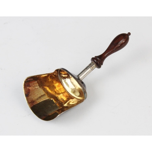 8 - A George III silver caddy spoon, Samuel Pemberton, Birmingham (date letter worn) with turned wooden ... 
