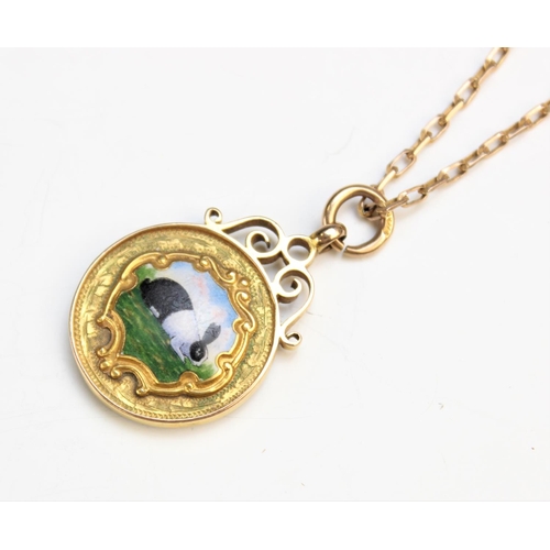 99 - A 9ct yellow gold and enamel Dutch rabbit pendant, the circular pendant fob with central panel depic... 