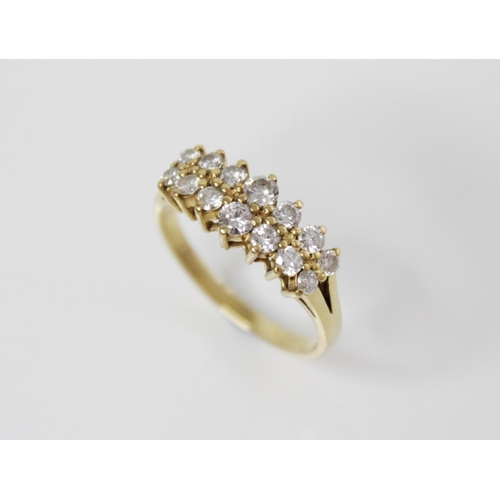 153 - A 18ct gold diamond set ring, comprising two rows of seven graduated round brilliant cut diamonds, (... 