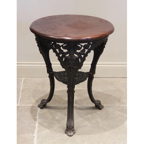 880 - A cast iron and hardwood Britannia type pub table, the  circular hardwood top above three cast mytho... 