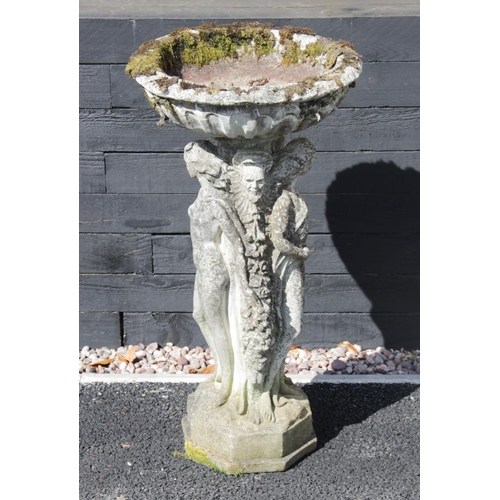 877 - A reconstituted stone figural bird bath, the circular bowl upon an integrated 'Three muses' figural ... 