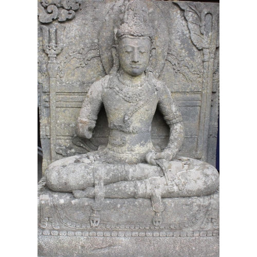 876 - A substantial 19th century carved stone architectural figure of Guanyin, modelled in a seated positi... 