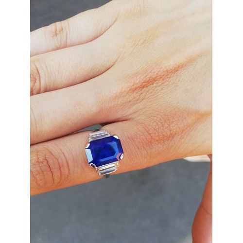 186 - An Art Deco sapphire and diamond ring, the central octagonal step cut sapphire (measuring 11.79mm L ... 