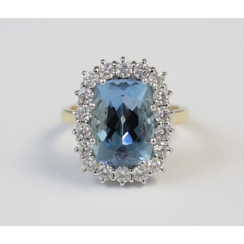 141 - An aquamarine and diamond 18ct gold cluster ring, the central rectangular mixed cut aquamarine (meas... 