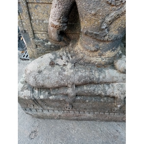 876 - A substantial 19th century carved stone architectural figure of Guanyin, modelled in a seated positi... 