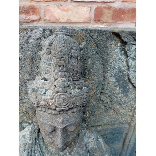 876 - A substantial 19th century carved stone architectural figure of Guanyin, modelled in a seated positi... 