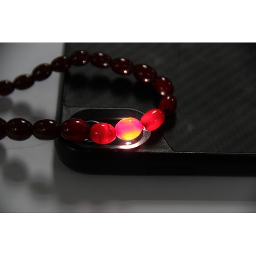 128 - A cherry amber bead necklace, comprising fifty-seven polished oval beads measuring between 8mm x 6mm... 