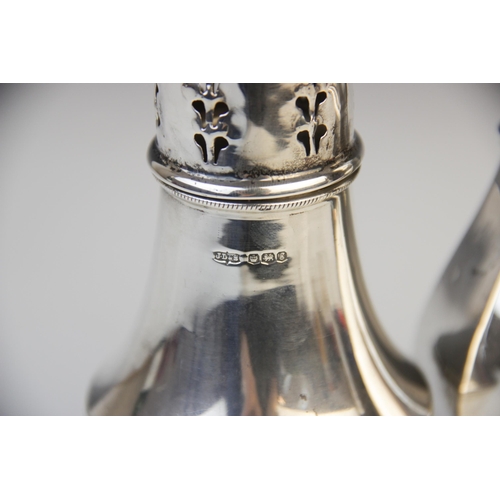 102 - An Edwardian silver sugar caster by Barker Brothers, Chester 1909, of faceted baluster form with pie... 