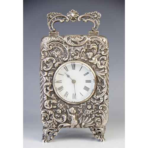 112 - An Edwardian repousse silver carriage timepiece, Elkington & Co, London 1901, the 'C' scroll openwor... 