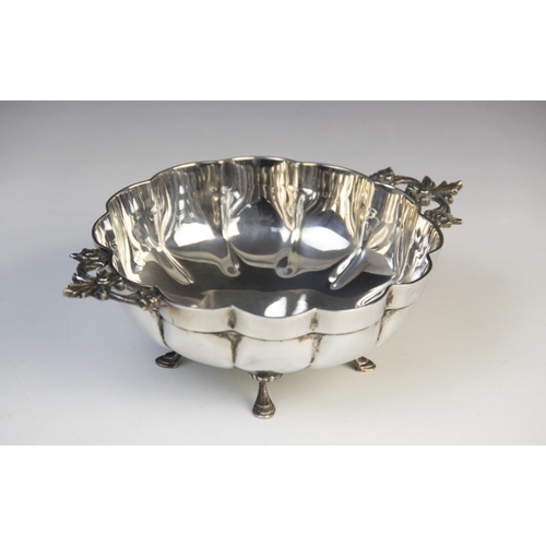 122 - A late 19th century white metal bon-bon dish, of lobed circular form with pierced scrolling handles ... 