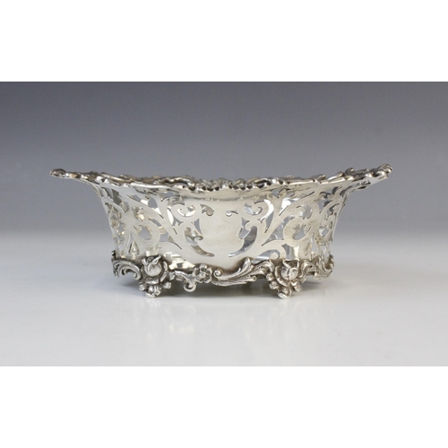 133 - An Edwardian silver bon-bon dish by Charles Wilkes, Birmingham 1910, of oval form with pierced scrol... 