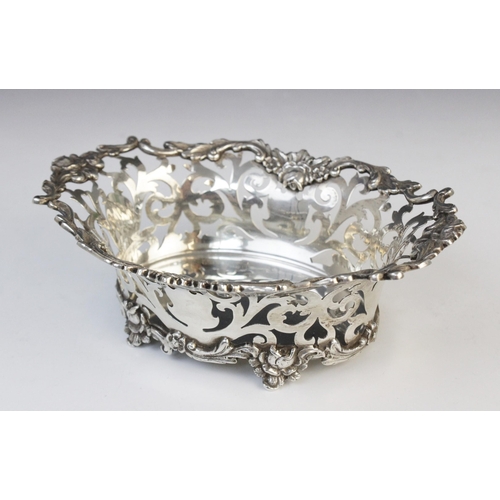 133 - An Edwardian silver bon-bon dish by Charles Wilkes, Birmingham 1910, of oval form with pierced scrol... 