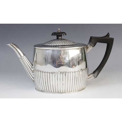 135 - A George III silver teapot by Michael Plummer, London 1793, of oval form with half-reeded decoration... 