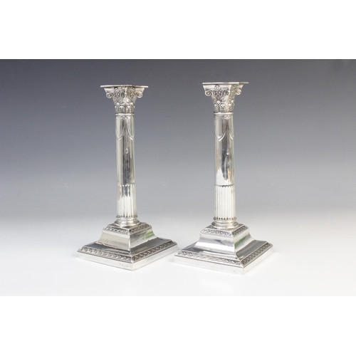 136 - A pair of late Victorian silver candlesticks by Goldsmiths & Silversmiths Co, London 1899, the Corin... 