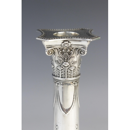 136 - A pair of late Victorian silver candlesticks by Goldsmiths & Silversmiths Co, London 1899, the Corin... 