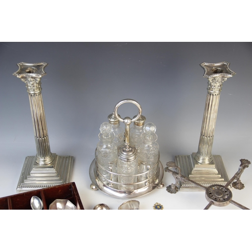 143 - A selection of silver plated tableware, to include: a pair of silver plated Corinthian column candle... 