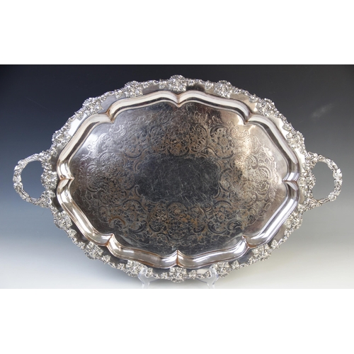 150 - A large twin handled silver-plated presentation tray, 19th century, of oval form with foliate cast r... 