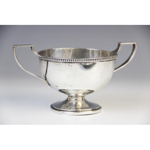 19 - A twin-handled silver trophy cup Walker & Hall, Sheffield 1960, of circular form with cast rim and a... 