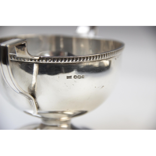 19 - A twin-handled silver trophy cup Walker & Hall, Sheffield 1960, of circular form with cast rim and a... 