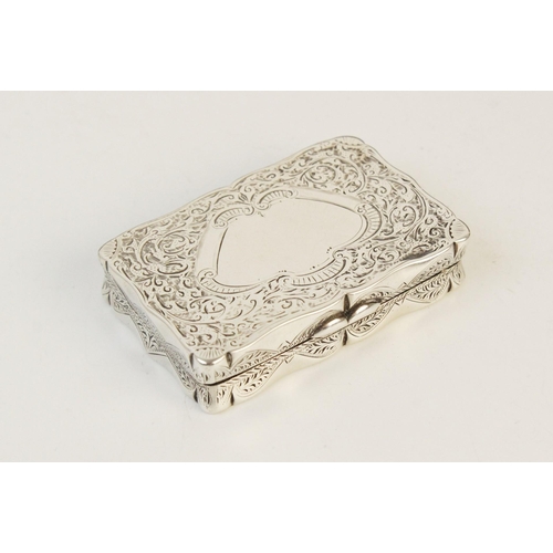 22 - A Victorian silver snuff box by Joseph Gloster, Birmingham 1892, of rectangular form with shaped bor... 