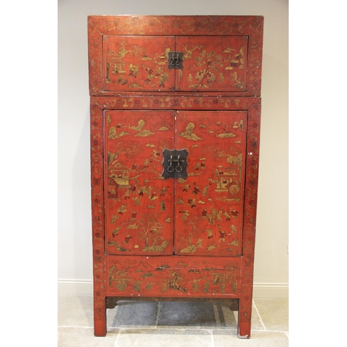 898 - A Chinese red lacquer chinoiserie two piece cabinet, early 20th century, the upper section with two ... 