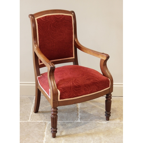 902 - A Victorian mahogany open library armchair, the padded back extending to down swept arms and scrolle... 