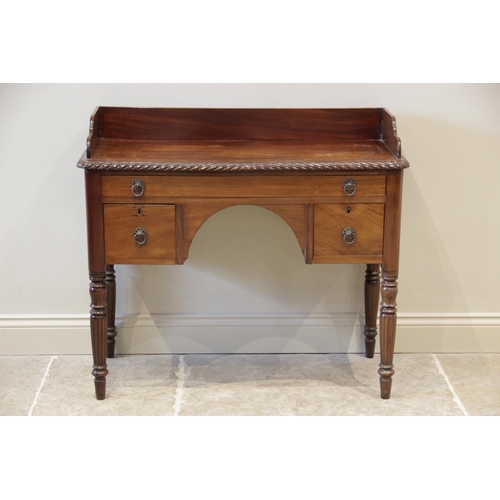 913 - A late 19th century mahogany dressing table, the three quarter galleried top with a gadrooned edge, ... 