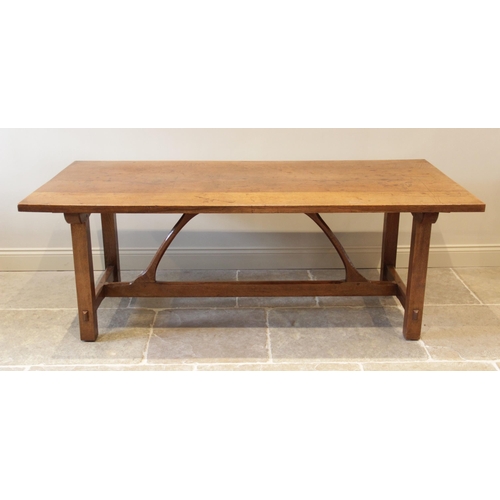 918 - An early 20th century Arts and Crafts honey oak refectory table in the manner of Ernest Gimson (1864... 