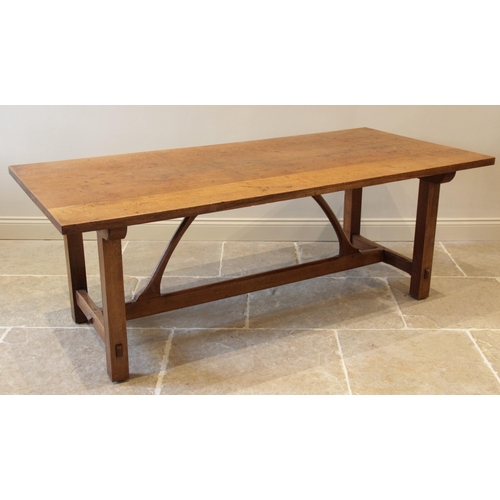 918 - An early 20th century Arts and Crafts honey oak refectory table in the manner of Ernest Gimson (1864... 