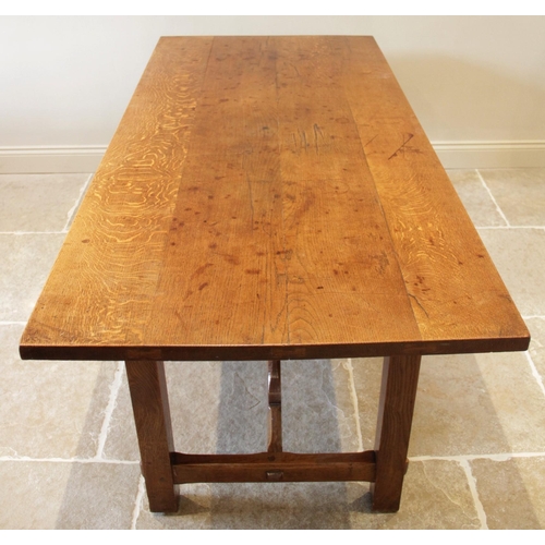 918 - An early 20th century Arts and Crafts honey oak refectory table in the manner of Ernest Gimson (1864... 