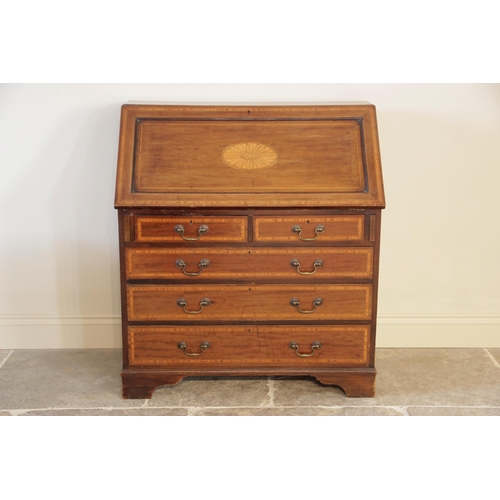 924 - An Edwardian Sheraton revival mahogany and satinwood crossbanded bureau, the fall front centred with... 