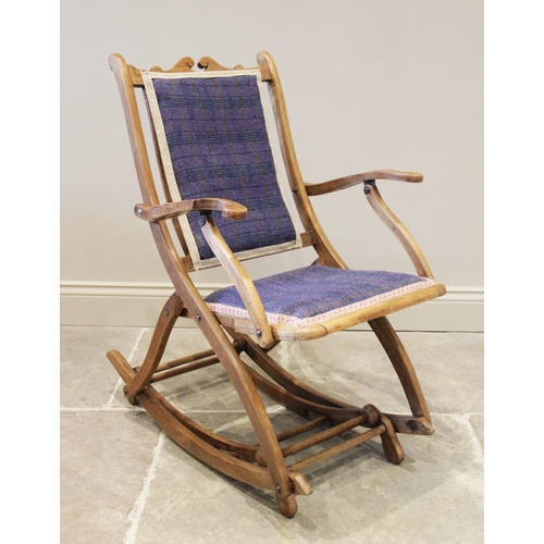 925 - A late 19th century adjustable beech wood rocking chair, probably French, with a padded back rest an... 