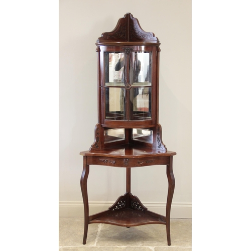 926 - An Edwardian mahogany freestanding corner display cabinet, the bow front glazed cabinet above a gall... 